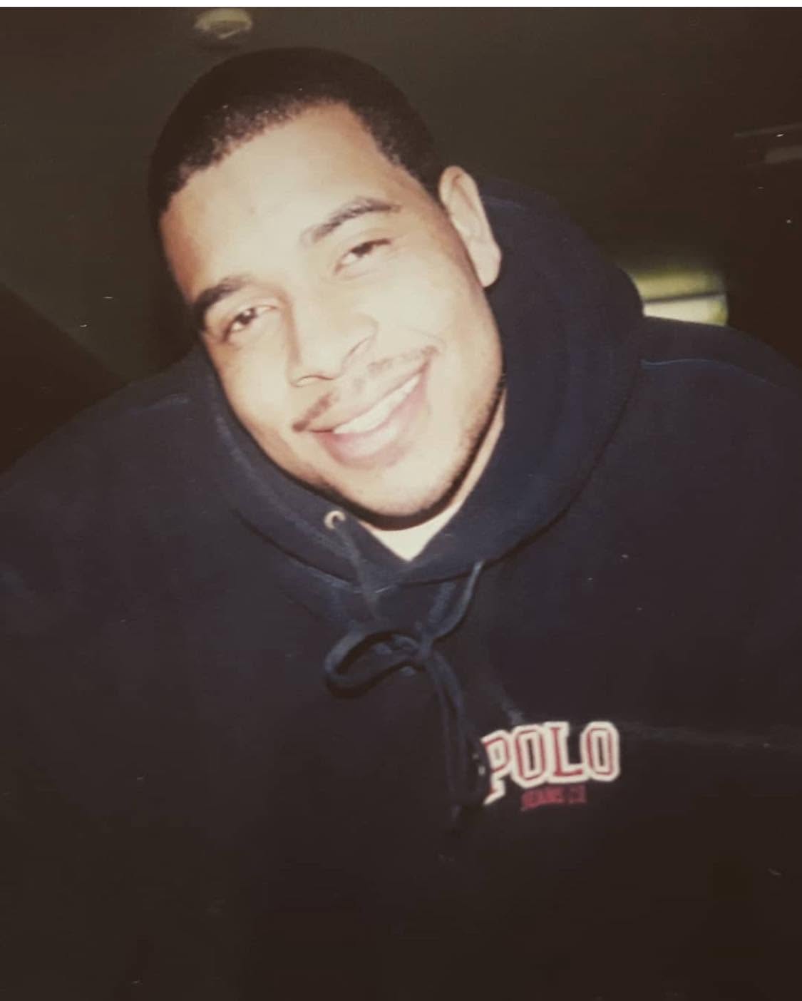 Caleb Lampkin Love smiling in a navy hoodie